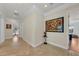Hallway with decorative art, leading to other rooms in the home; tile flooring at 550 Yardarm Ln, Longboat Key, FL 34228