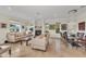 Expansive living room with neutral furniture, fireplace, and elegant dining area with chandelier at 550 Yardarm Ln, Longboat Key, FL 34228