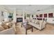 Spacious living room featuring a cozy fireplace and comfortable seating, complemented by a dining area at 550 Yardarm Ln, Longboat Key, FL 34228