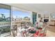 Covered patio with a dining table overlooking the canal at 550 Yardarm Ln, Longboat Key, FL 34228