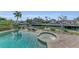 Waterfront backyard features a swimming pool, spa, and canal views at 550 Yardarm Ln, Longboat Key, FL 34228