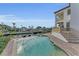 Inviting pool area with canal views, lounge chairs, and a spa for relaxation and outdoor enjoyment at 550 Yardarm Ln, Longboat Key, FL 34228