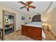 Bedroom features terra cotta tile flooring, ceiling fan and views into the kitchen at 631 43Rd Street W Blvd, Palmetto, FL 34221