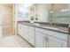 Elegant bathroom with double vanity, granite countertop, and walk-in shower at 12826 Sorrento Way, Bradenton, FL 34211