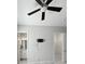 Bright bedroom with a ceiling fan, wall-mounted TV bracket, and doorways to a bathroom and closet at 12826 Sorrento Way, Bradenton, FL 34211