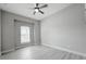 Simple bedroom with hardwood floors, a window with blinds, and a ceiling fan at 12826 Sorrento Way, Bradenton, FL 34211
