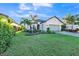 Charming single-story home featuring a lush green lawn, tropical landscaping, and a two-car garage at 12826 Sorrento Way, Bradenton, FL 34211