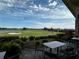 Picturesque view of a golf course from a patio with outdoor seating at 12826 Sorrento Way, Bradenton, FL 34211