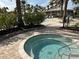 Inviting hot tub with paver surround, lush landscaping and a nearby bar, perfect for unwinding and socializing at 12826 Sorrento Way, Bradenton, FL 34211