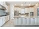 Modern kitchen with white cabinets, stainless steel appliances, and a large center island at 12826 Sorrento Way, Bradenton, FL 34211