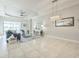 Spacious living room features tile floors, sliding glass doors, and tray ceilings at 12826 Sorrento Way, Bradenton, FL 34211