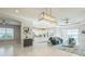 Open-concept living space with a modern kitchen, comfortable seating area, and a view of the outdoor pool at 12826 Sorrento Way, Bradenton, FL 34211