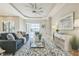 Cozy living room featuring a comfortable sofa, stylish rug, and sliding glass doors with views of the pool at 12826 Sorrento Way, Bradenton, FL 34211