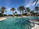 Luxury swimming pool with sun loungers and palm trees in Esplanade Golf and Country Club at 12826 Sorrento Way, Bradenton, FL 34211