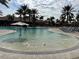 Expansive pool area with comfortable lounge chairs and sun umbrellas, perfect for relaxation and recreation at 12826 Sorrento Way, Bradenton, FL 34211