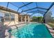 A stunning screened-in pool with sparkling blue water and a covered patio, perfect for outdoor relaxation and entertainment at 12826 Sorrento Way, Bradenton, FL 34211