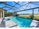 Inviting screened-in pool with a lake view, hot tub, and brick patio, perfect for relaxation at 12826 Sorrento Way, Bradenton, FL 34211