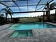 Beautiful pool and spa within a screened enclosure, overlooking a golf course and lake at 12826 Sorrento Way, Bradenton, FL 34211