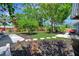 Expansive backyard features a well-maintained lawn, mature trees, and a charming pergola at 3902 11Th W Ave, Bradenton, FL 34205