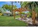 Relaxing outdoor space with a pergola, seating, and lush green lawn at 3902 11Th W Ave, Bradenton, FL 34205