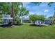 Spacious backyard with manicured lawn and mature trees for shade at 3902 11Th W Ave, Bradenton, FL 34205