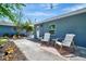 Cozy backyard patio with two white chairs, a small table, and a well-maintained exterior at 3902 11Th W Ave, Bradenton, FL 34205
