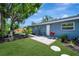 Spacious backyard featuring a lush lawn, patio area with grill, and mature shade trees at 3902 11Th W Ave, Bradenton, FL 34205