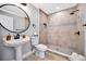 Modern bathroom features a tiled walk-in shower, stylish fixtures, and a pedestal sink, offering a clean and refreshing space at 3902 11Th W Ave, Bradenton, FL 34205
