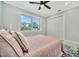 Bright bedroom featuring a ceiling fan, natural light, and closet with shutter doors at 3902 11Th W Ave, Bradenton, FL 34205