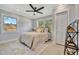 Bright bedroom featuring a ceiling fan and closet with shutter doors at 3902 11Th W Ave, Bradenton, FL 34205