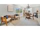 A cozy and modern dining space with an accent painting and view through a doorway to an eat-in kitchen at 3902 11Th W Ave, Bradenton, FL 34205
