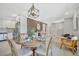 The dining table is flanked by the kitchen, the bar area, and another living space in this open concept home at 3902 11Th W Ave, Bradenton, FL 34205