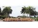 Picturesque golf course entrance with manicured landscaping, palm trees, and decorative features at 3902 11Th W Ave, Bradenton, FL 34205