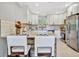 Bright kitchen features stainless steel appliances, white cabinets, and a center island with bar stool seating at 3902 11Th W Ave, Bradenton, FL 34205