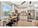Bright and open kitchen featuring white cabinets, stainless steel appliances, and an adjacent dining area at 3902 11Th W Ave, Bradenton, FL 34205