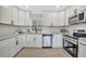 Bright kitchen boasts white cabinets, subway tile backsplash, and stainless steel appliances creating a clean and modern space at 3902 11Th W Ave, Bradenton, FL 34205