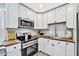 Well-appointed kitchen with white cabinetry, wood countertops, and stainless steel appliances and fixtures at 3902 11Th W Ave, Bradenton, FL 34205