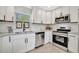 Modern kitchen features white cabinetry, stainless steel appliances, and a sleek design, great for cooking and entertaining at 3902 11Th W Ave, Bradenton, FL 34205