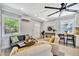 Inviting living room showcasing stylish furniture, a ceiling fan, and natural light from the windows at 3902 11Th W Ave, Bradenton, FL 34205