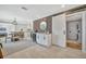 An open concept floorplan shows a bar, dining and other living space, with light flooring and modern fixtures at 3902 11Th W Ave, Bradenton, FL 34205