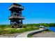Wooden observation tower with scenic views, surrounded by lush greenery and a clear blue sky at 3902 11Th W Ave, Bradenton, FL 34205