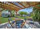 Charming backyard pergola with outdoor seating, perfect for entertaining and enjoying the view at 3902 11Th W Ave, Bradenton, FL 34205