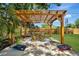 Backyard features a charming pergola with outdoor seating and a bean bag toss game at 3902 11Th W Ave, Bradenton, FL 34205