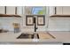 A stylish sink features modern fixtures, quartz countertops, and tasteful décor, enhancing the kitchen's overall aesthetic appeal at 3902 11Th W Ave, Bradenton, FL 34205