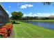 Enjoy this backyard with a picturesque pond view, lush green lawn, mature landscaping, and plenty of space at 4020 Cascina Way, Sarasota, FL 34238