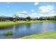 This home features a tranquil pond view, lush lawn, and serene backyard with a screened-in lanai at 4020 Cascina Way, Sarasota, FL 34238