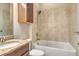 Bathroom with tiled shower/tub, granite countertop, and wood cabinet at 4020 Cascina Way, Sarasota, FL 34238
