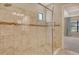 Tiled shower with glass door and decorative accent tile, offering a spa-like experience at 4020 Cascina Way, Sarasota, FL 34238