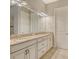 Bathroom with double vanity, granite counters, and updated fixtures at 4020 Cascina Way, Sarasota, FL 34238