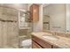 Bathroom with tiled shower, granite countertop, and wood cabinet at 4020 Cascina Way, Sarasota, FL 34238